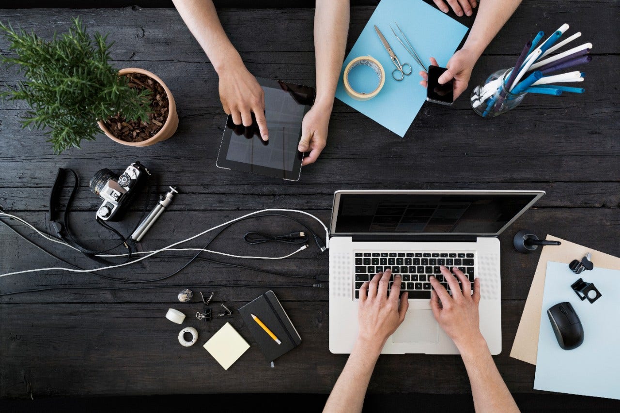 Digital devices with hands, tablet, laptop, smartphone